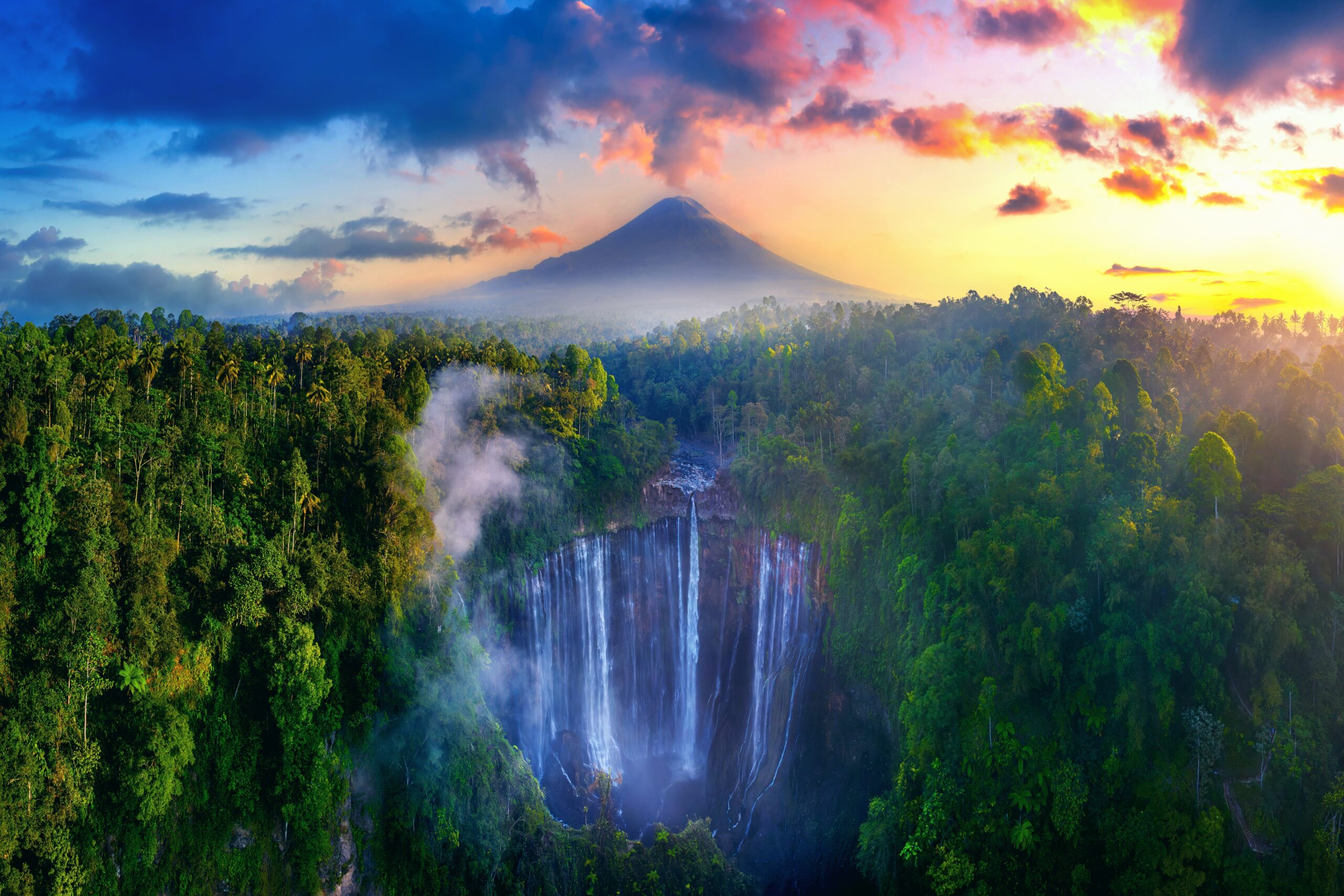 Tumpak Sewu Waterfall and Semeru mountain at sunrise, Indonesia