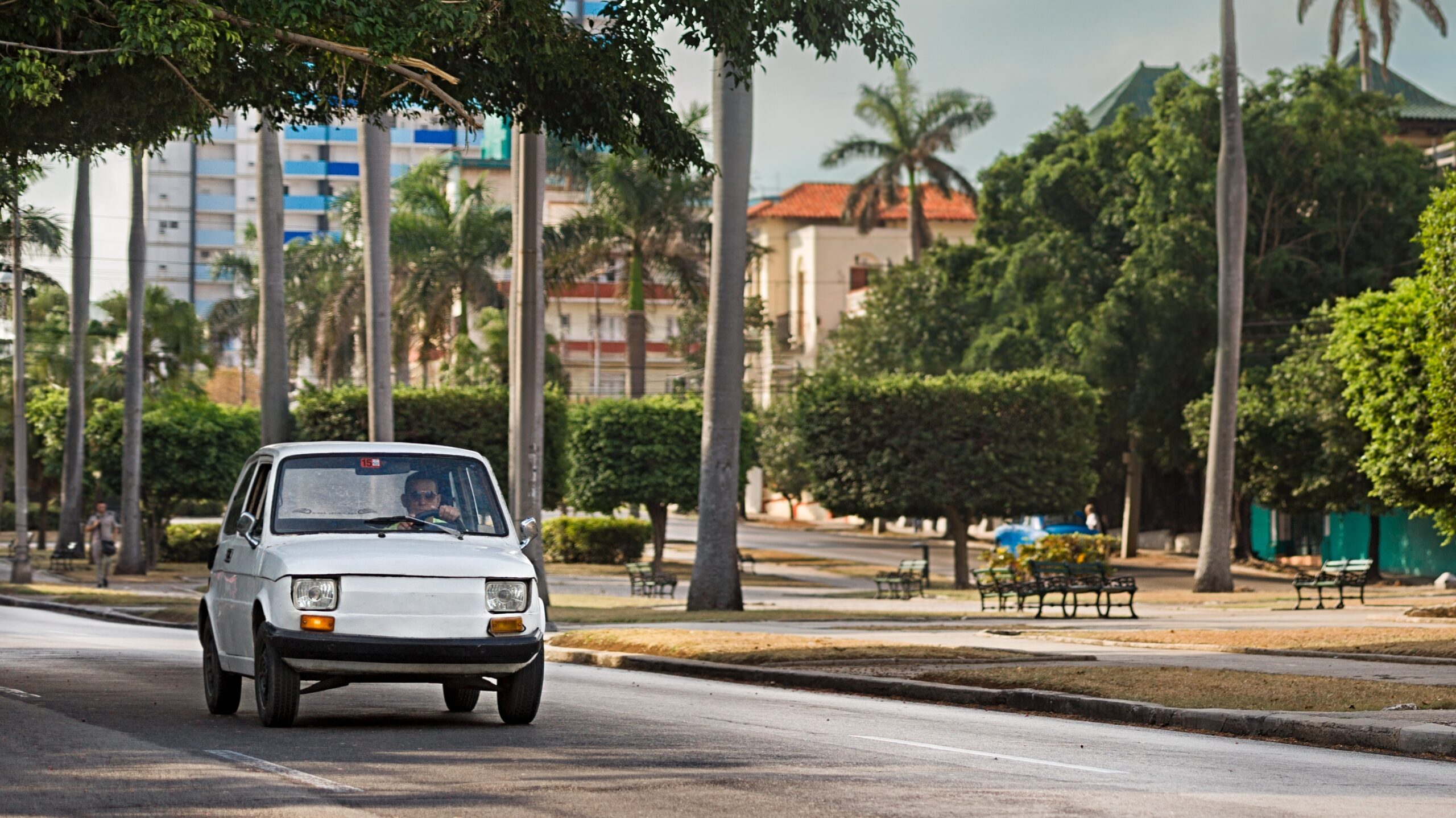 Havana, Cuba Apil 21st 2018: Polski Fiat 126p, vintage car, Havana, Cuba, Cuban streets, avenue, colonial architecture, classic car, urban scene, greenery, palm trees, cityscape, editorial.