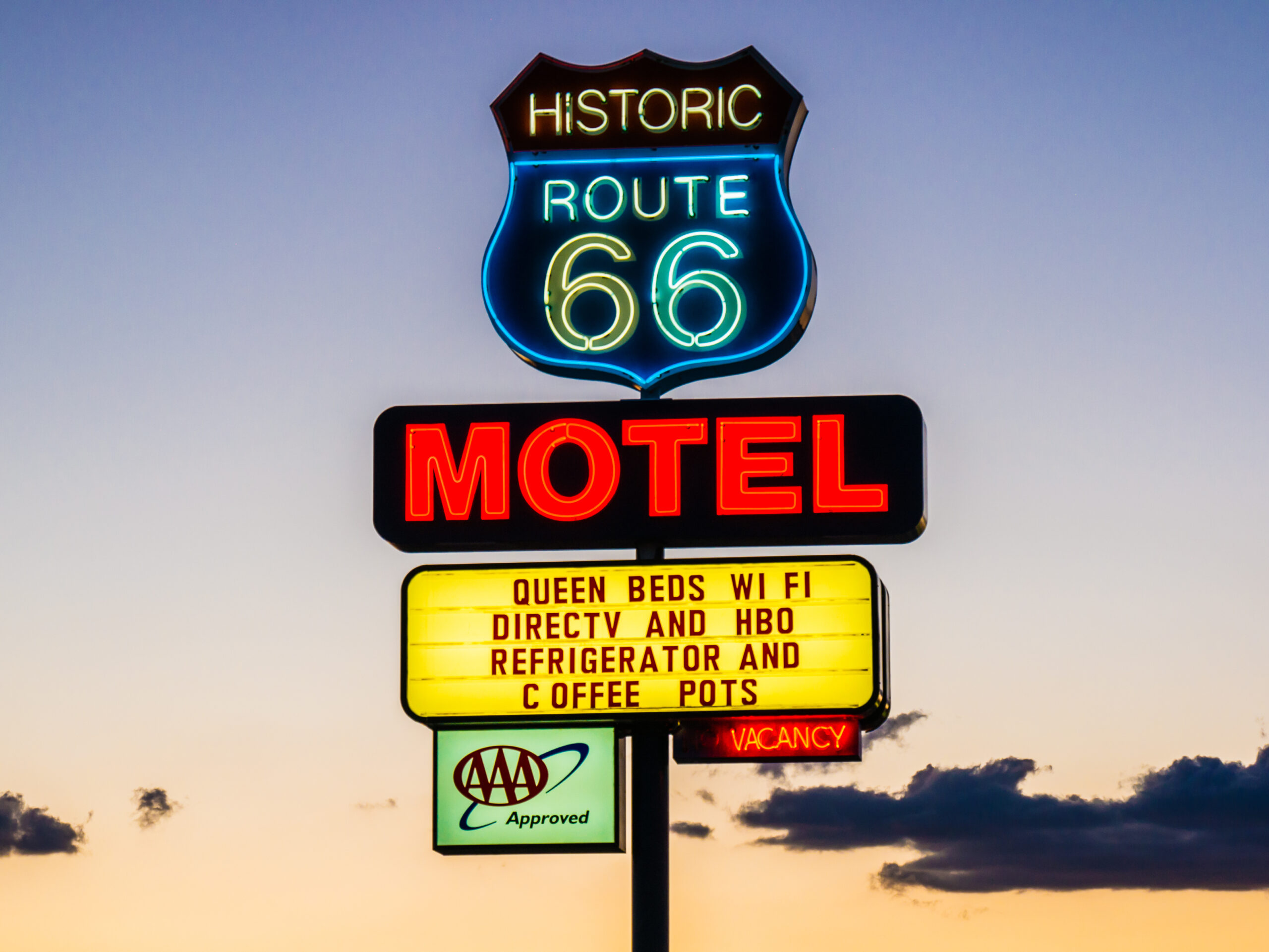 Historic motel sign along Route 66 in Arizona, photographed at sunset, reflecting the nostalgic roadside charm and classic Americana that continue to define the iconic highway