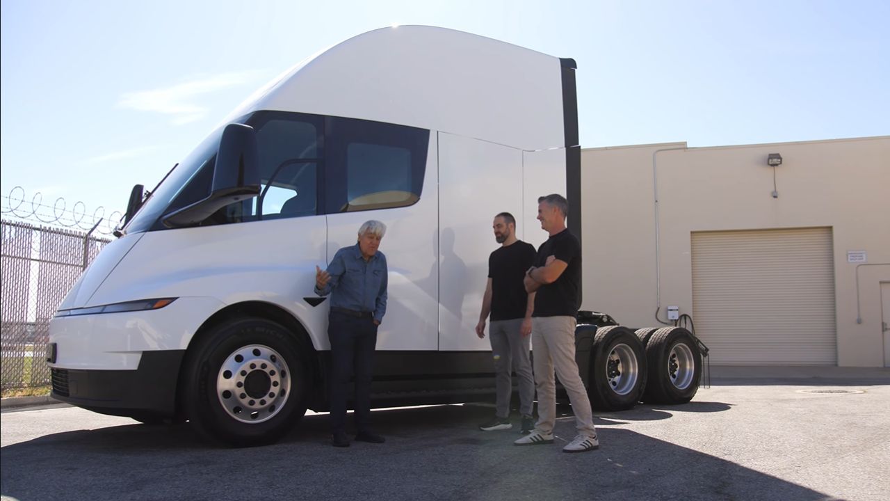 Front 3/4 view of Tesla Semi Truck featured on Jay Leno's Garage with Jay Leno and Tesla executives in front of it