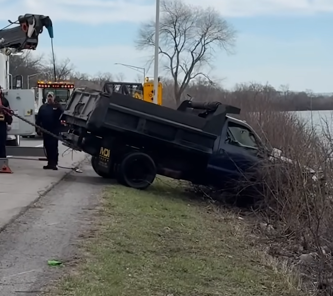dump truck crashes into lake after police chase