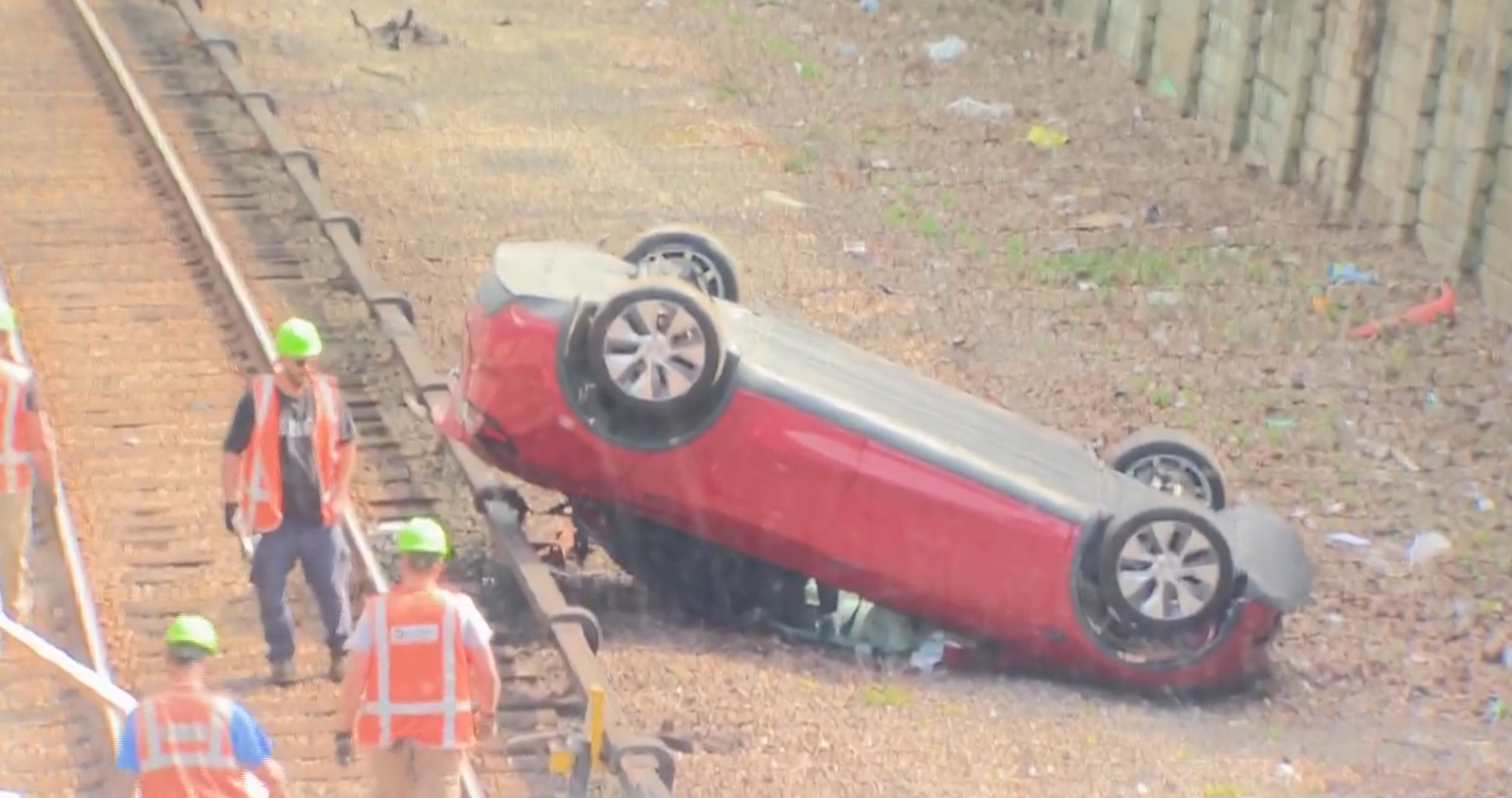 car flipped over on tracks