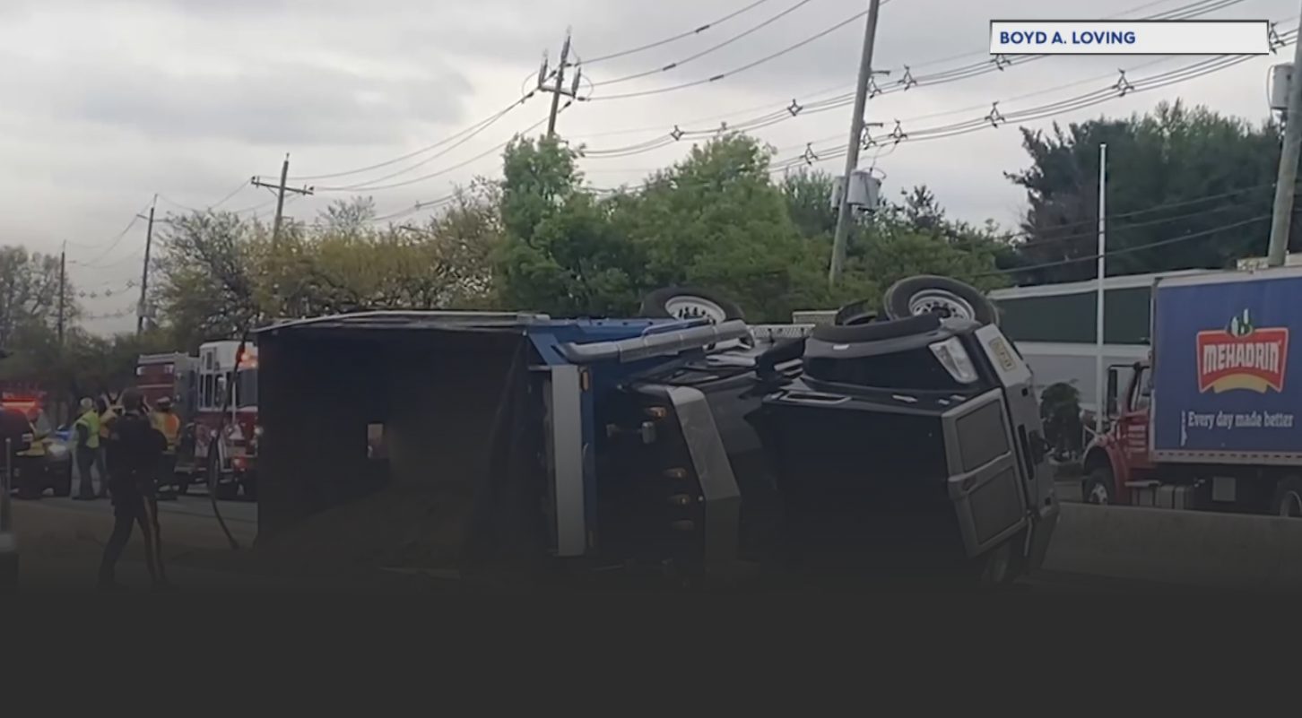 dump truck falls over on the road