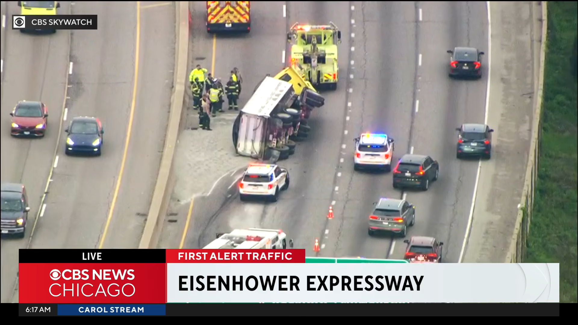 truck flips over on highway and spills gravel