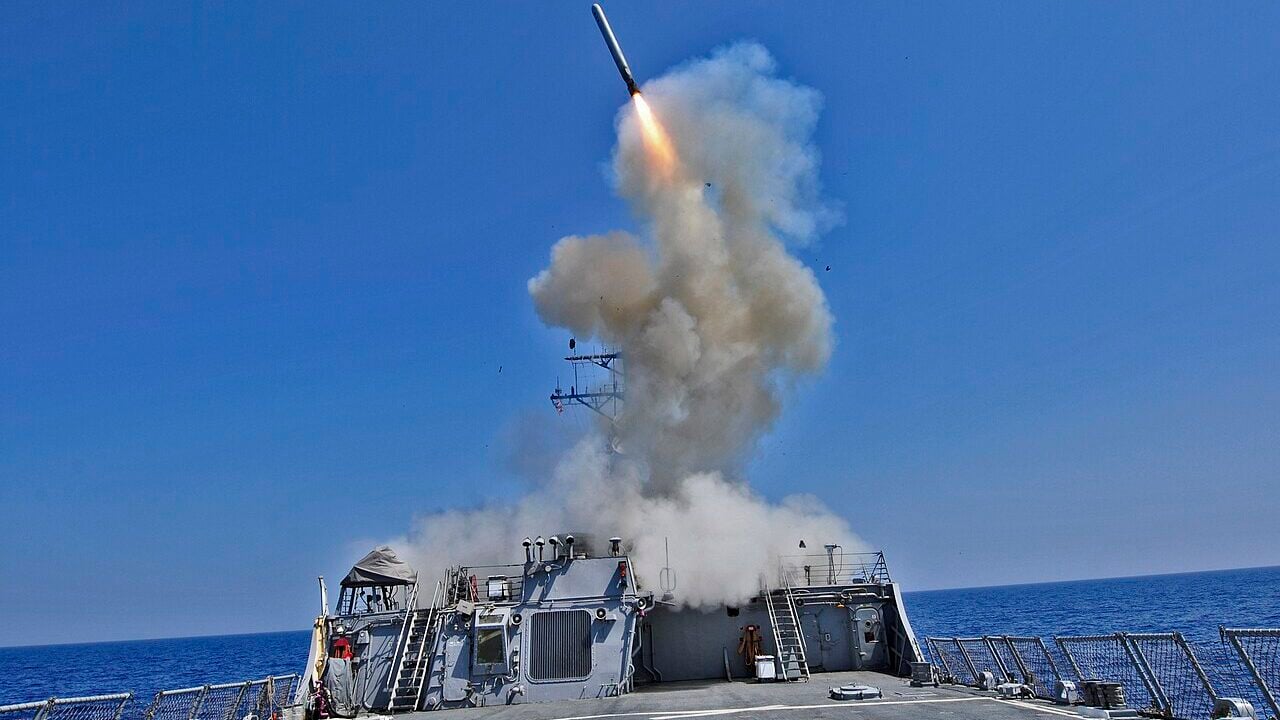 The Arleigh Burke-class guided-missile destroyer USS Barry (DDG 52) launches a Tomahawk cruise missile to support Joint Task Force Odyssey Dawn.