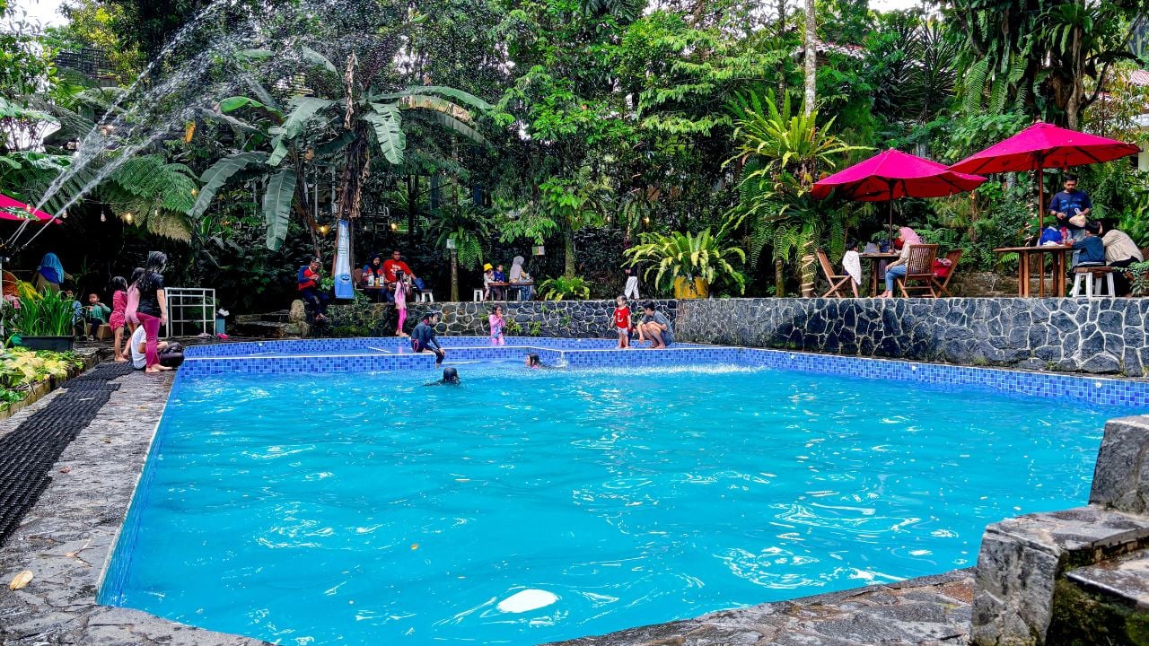 A campground pool surrounded by greenery shows how modern outdoor stays offer more than just nature, adding comfort and shared spaces for relaxation and fun.
