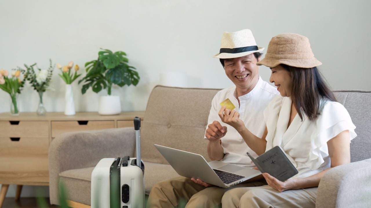 Couple planning travel costs on a laptop