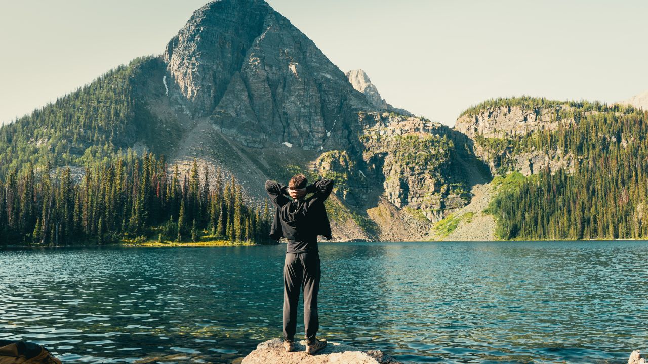 Hiker beside a mountain lake