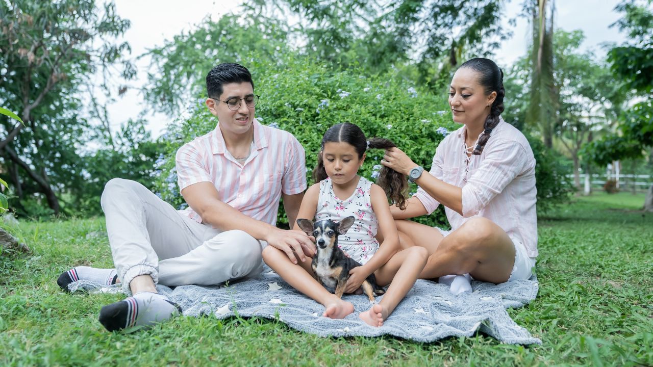 Mexican Family Relaxing in the Park, Enjoying with their Chihuahua Dog