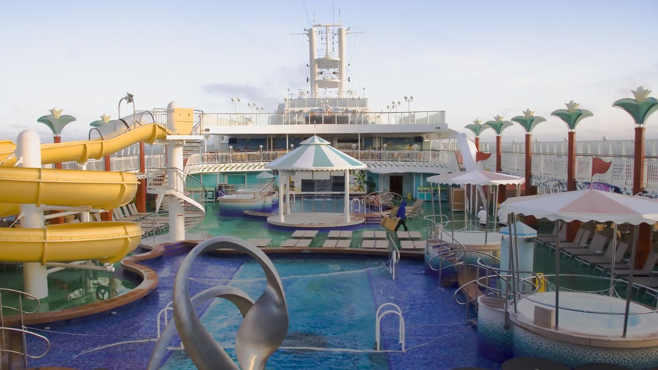 Cruise ship top deck with slides, pools, and hot tubs