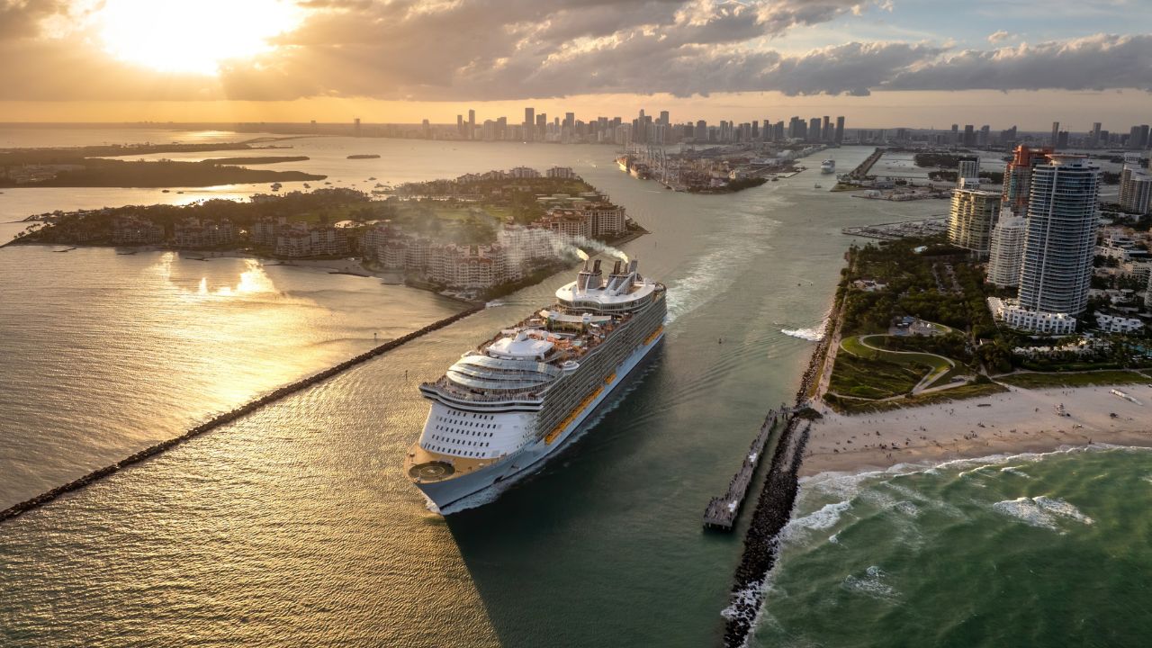 Big passenger cruise liner ship departing at main channel in Miami harbor near South Beach high luxurious hotels and apartment buildings