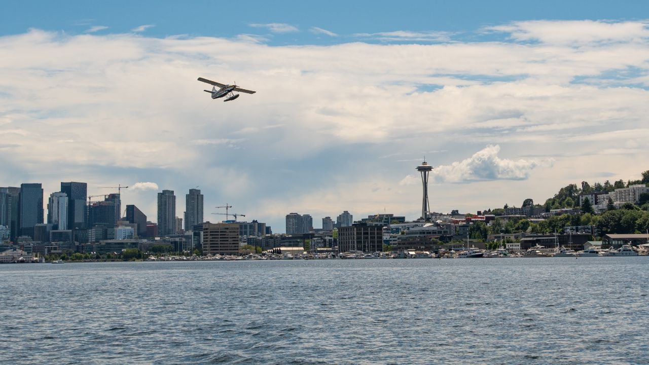 Sea Plane flying over Lake Union with the Seattle skyline in the background