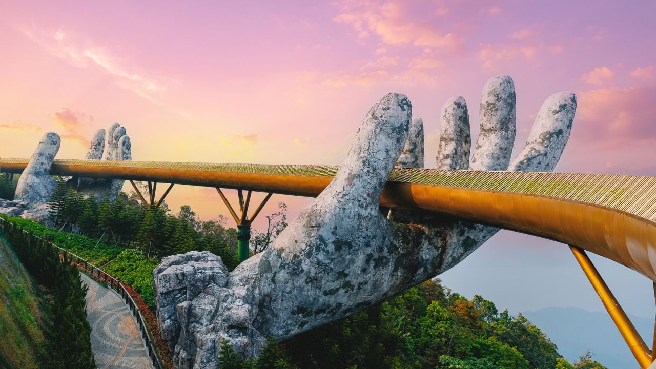 Golden bridge at sunrise in ba na hills, Da nang Vietnam with two giant stone hands.