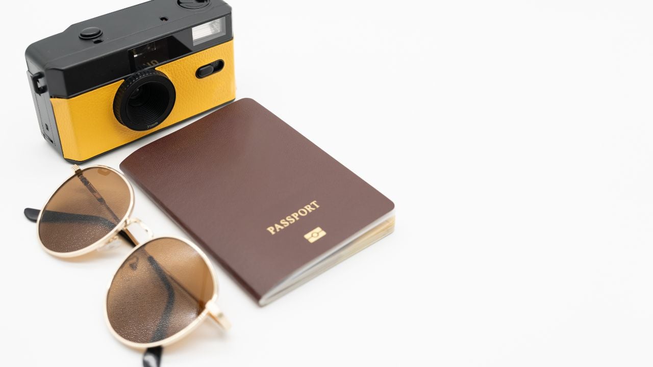 Vintage camera, Passport with Sunglasses. Minimal hipster summer trend. Retro design camera for travel. Summertime concept. Travel, Holiday, Vacation in summer concept.