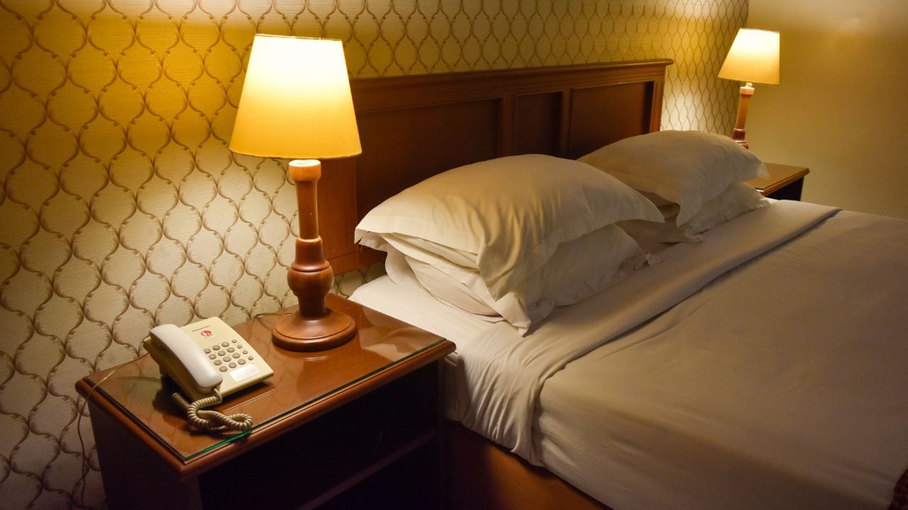 The telephone is on a table in a hotel room, lit by dim lighting. Banyuwangi, Indonesia, April 26, 2025