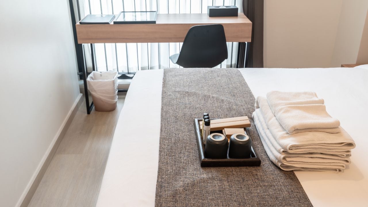 Set of hotel amenities (such as towels, shampoo, soap, toothbrush etc) on the bed. Hotel amenities is something of a premium nature provided in addition to the room when renting a room.