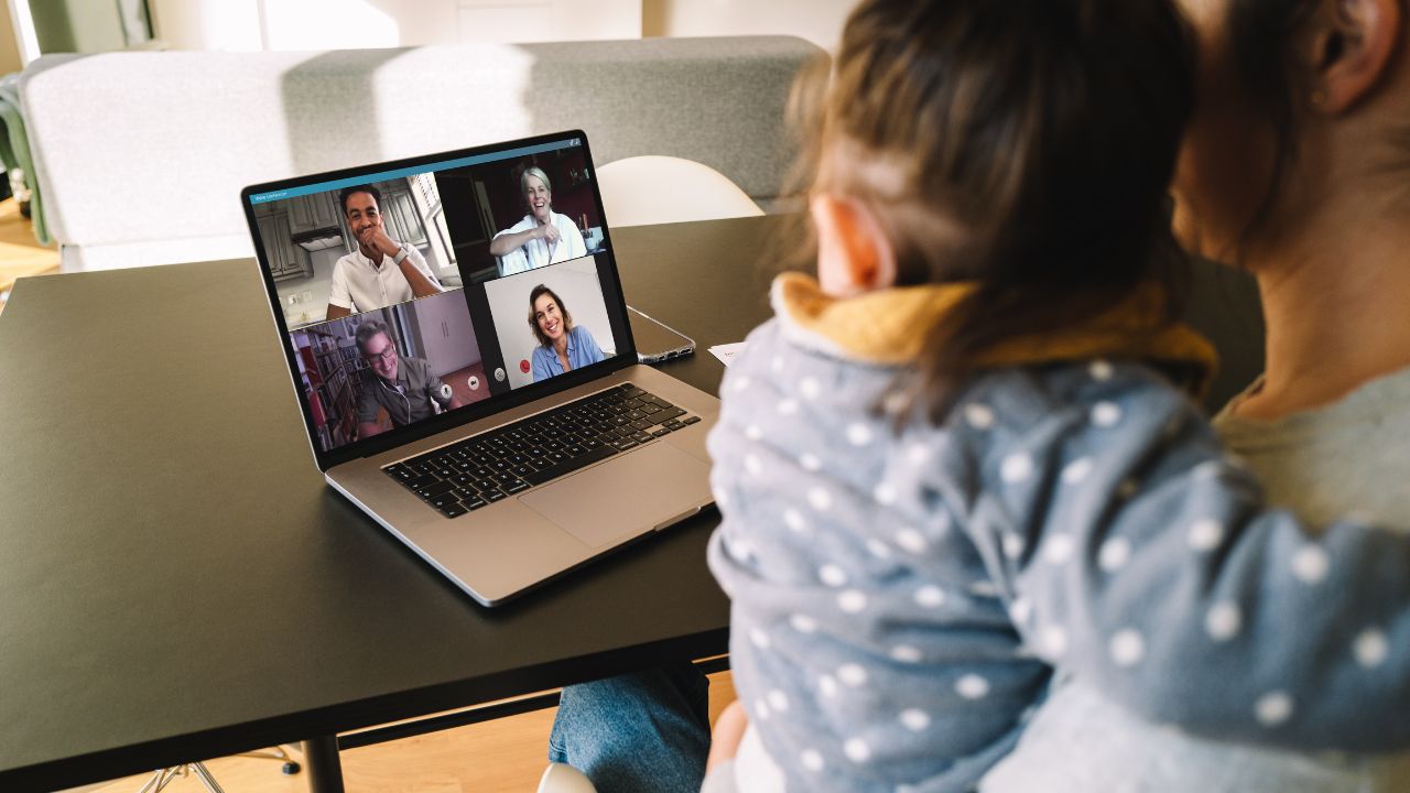 Woman and daughter at home having a video conference with her family and friends. Woman talking with her friends over internet.