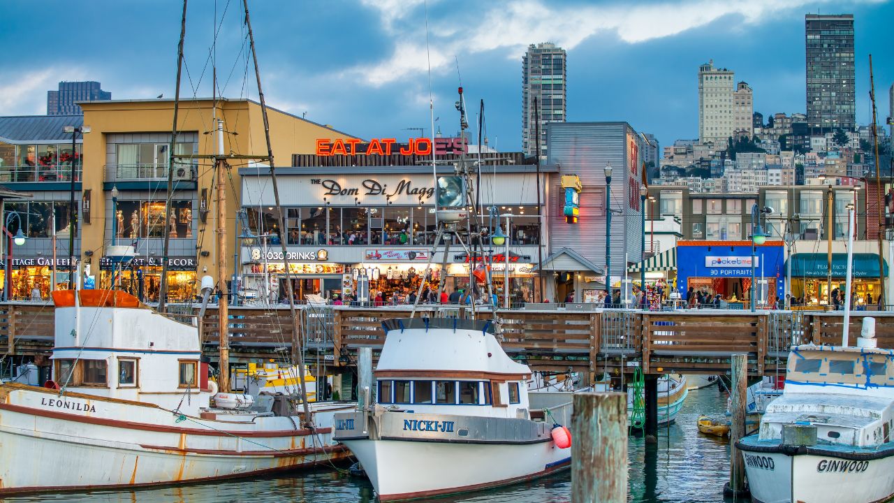 San Francisco, CA - August 6, 2017: City streets and buildings along Fisherman's Wharf at sunset.