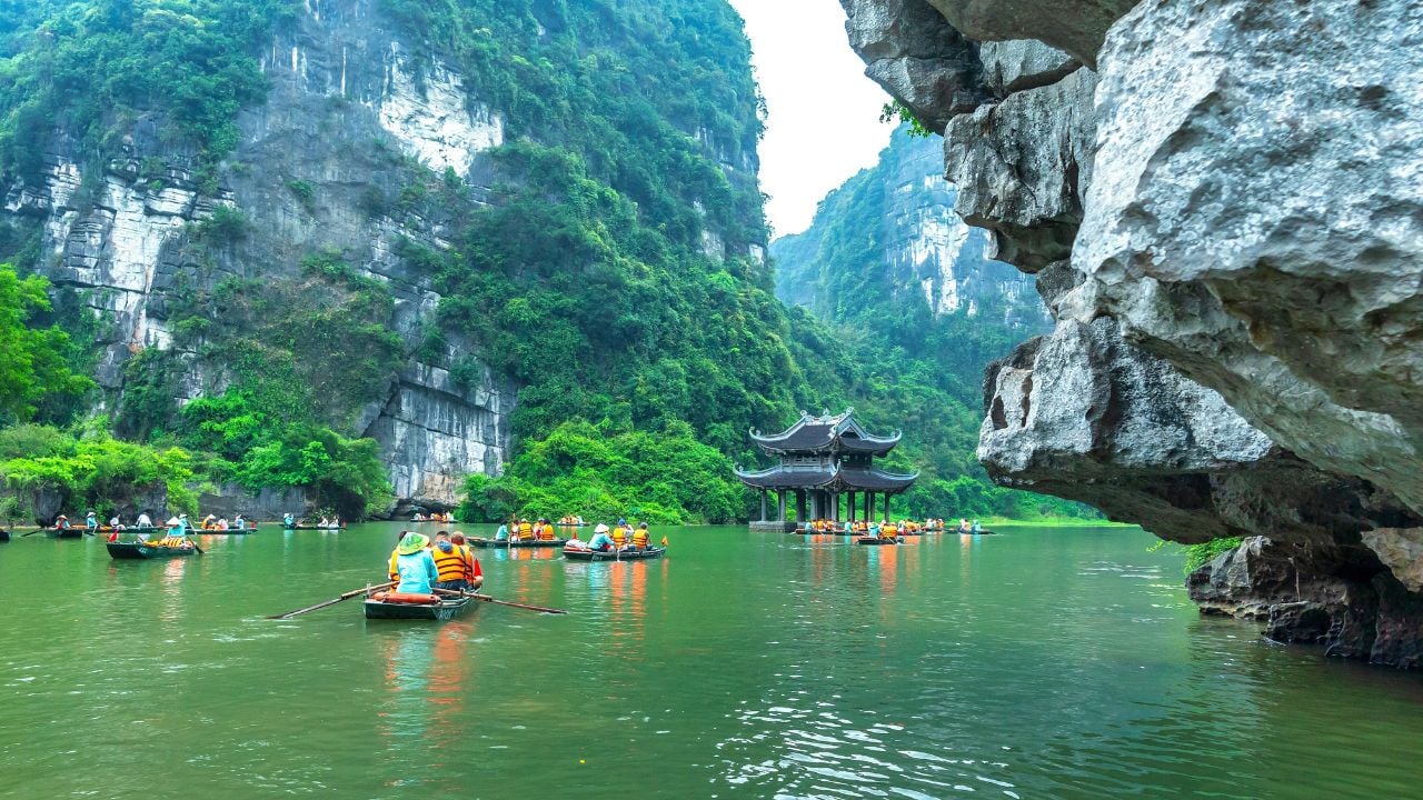 Tourists floating by boat in Trang An, Ninh Binh, Vietnam