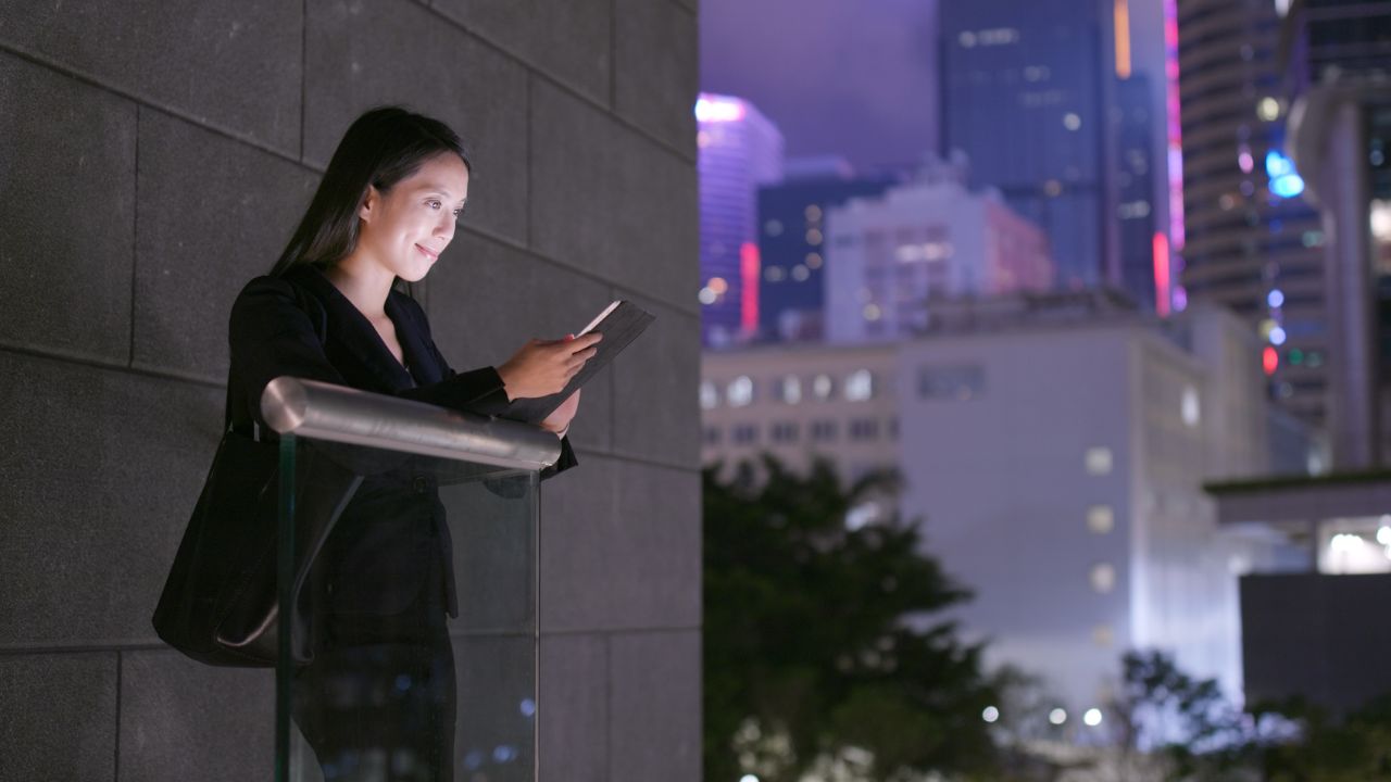 Businesswoman use of cellphone at night