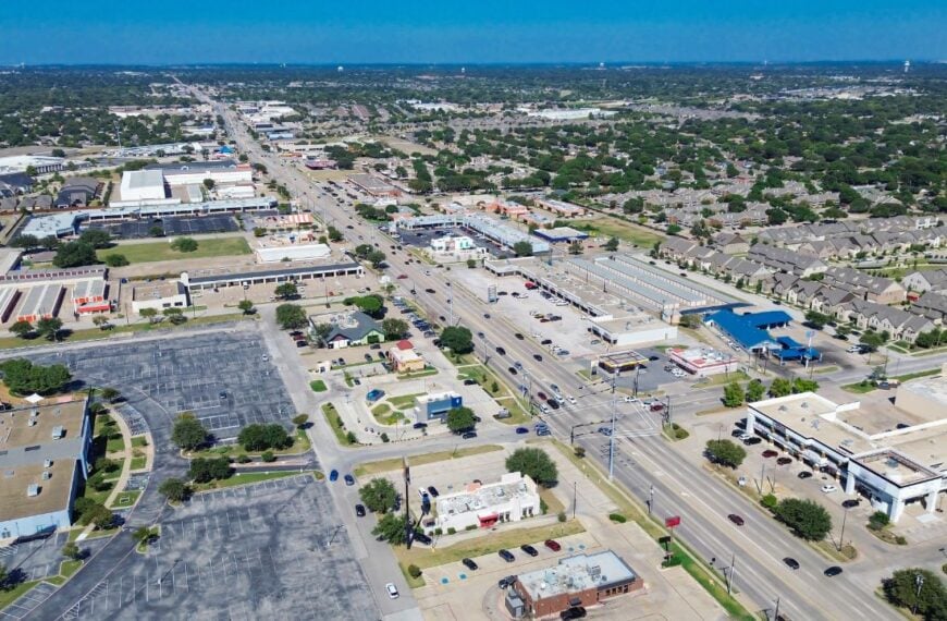 Downtown North Richland Hills, Texas showing freeway-front retail pads, restaurant zones, storage facility, business park, residential neighborhoods with organized street grids and green buffers. USA