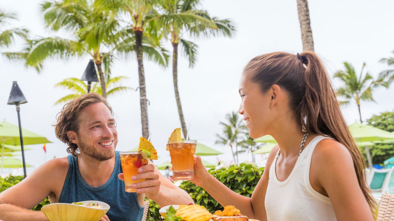 Couple having drinks at a hotel restaurant during a Hawaii beach vacation