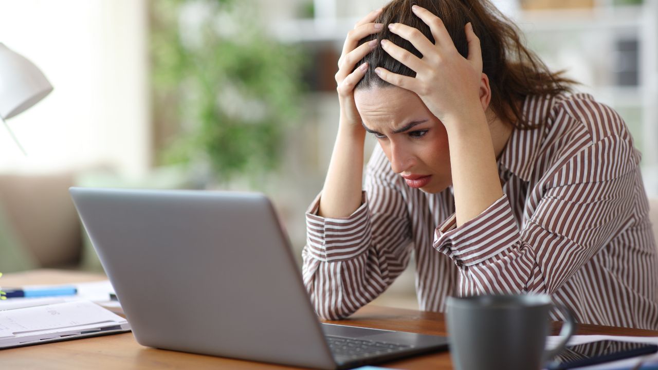 Worried self employed complaining after discover online mistale on laptop working at home