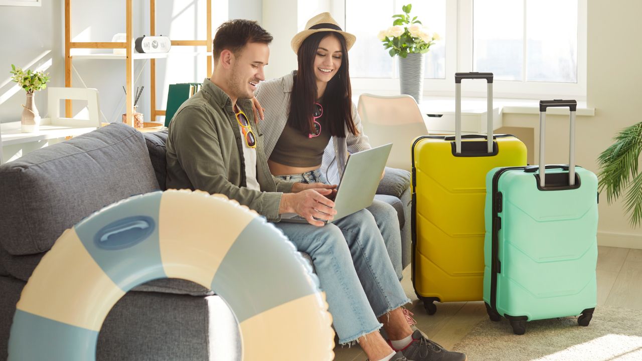 Couple planning a vacation on a laptop
