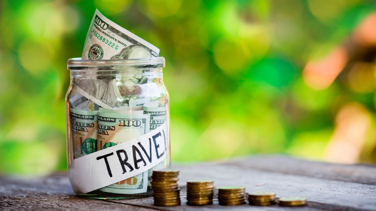 Travel savings jar with cash inside