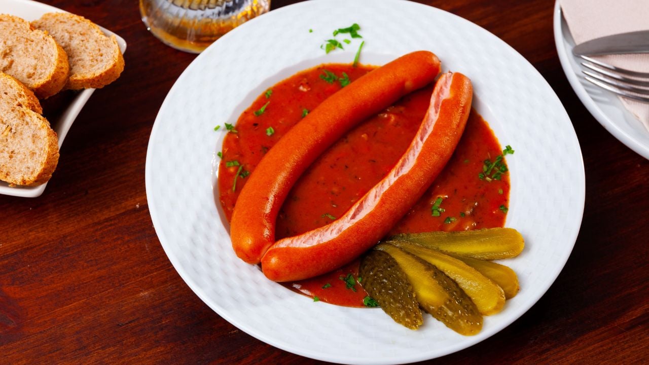 Fresh portion of Viennese goulash with sausages served on table