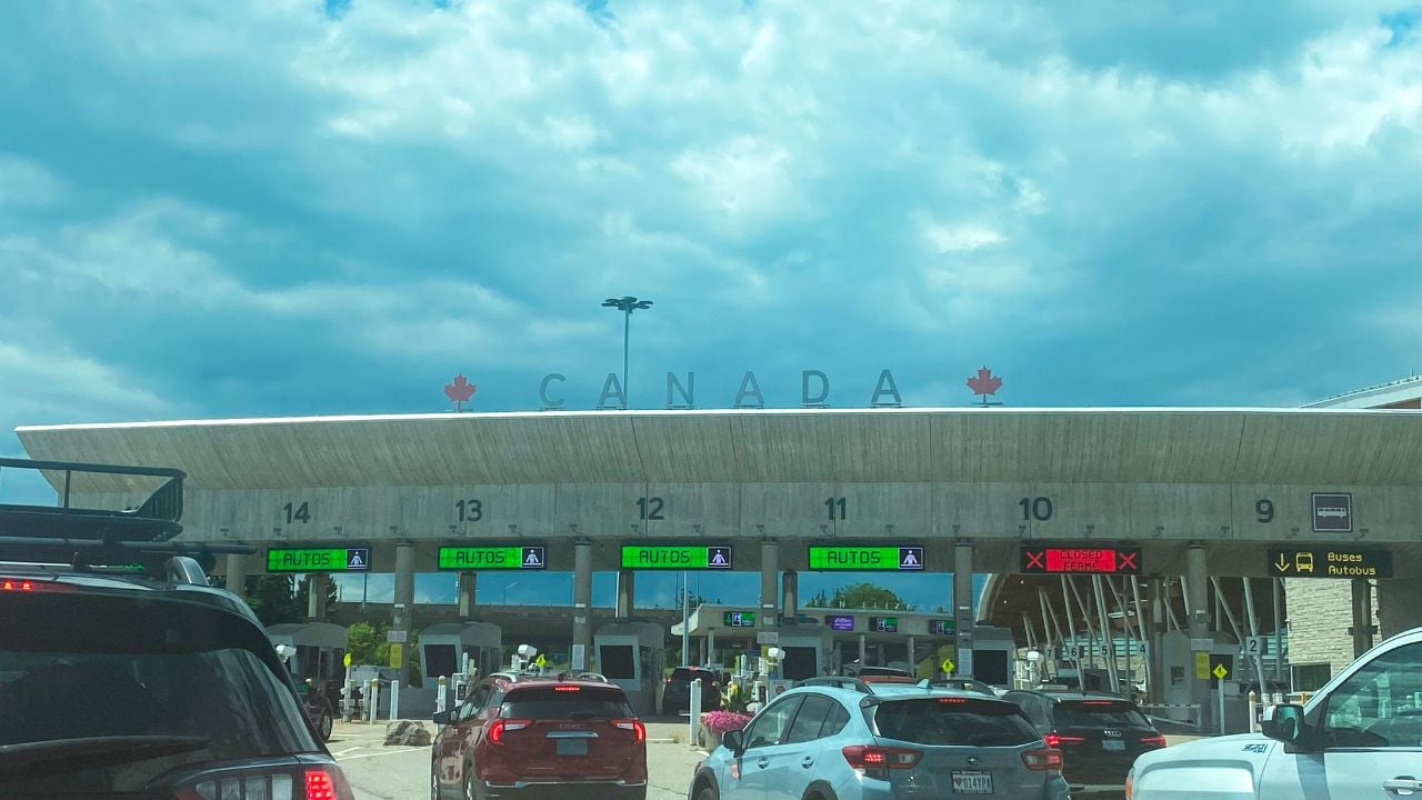 Buffalo, New York, USA - 4 August 2023: Cars line up at the Canada border crossing under a cloudy sky with electronic signs visible.