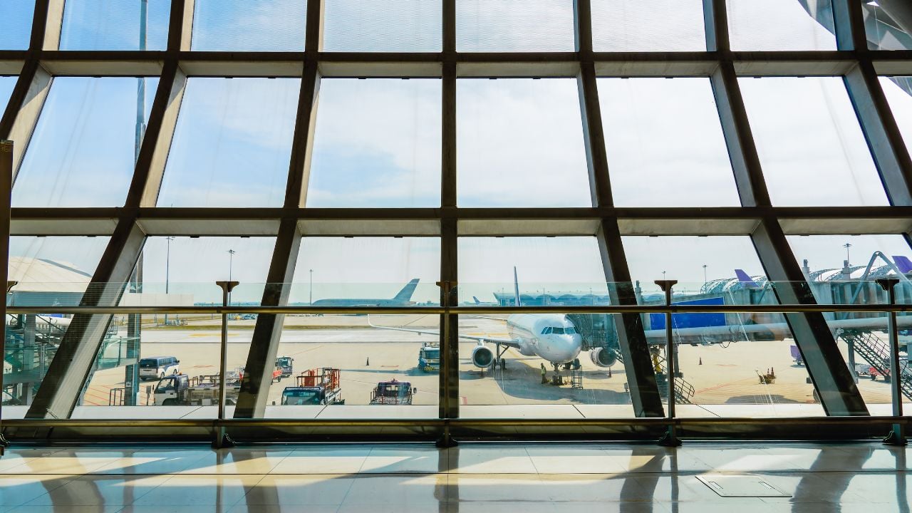 Airport terminal window with a view of an airplane