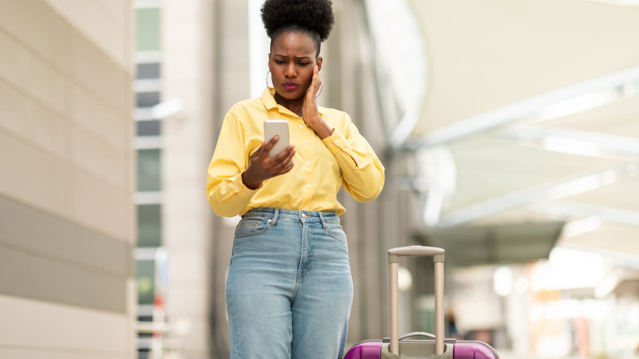 Traveler checking phone for a tight airport connection