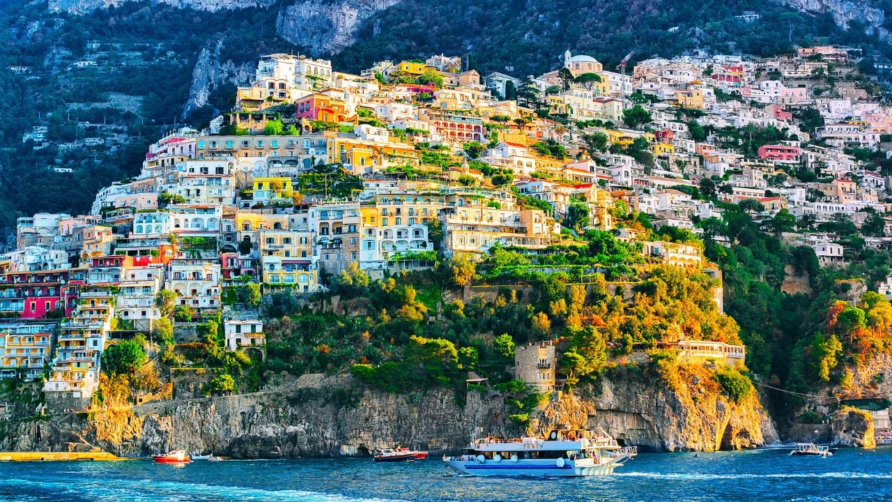 Cityscape and coastal landscape at Italian Positano luxury town on Amalfi Coast and Tyrrhenian Sea in Italy in summer. View of Amalfitana coastline. Vacation and holiday near Salerno.