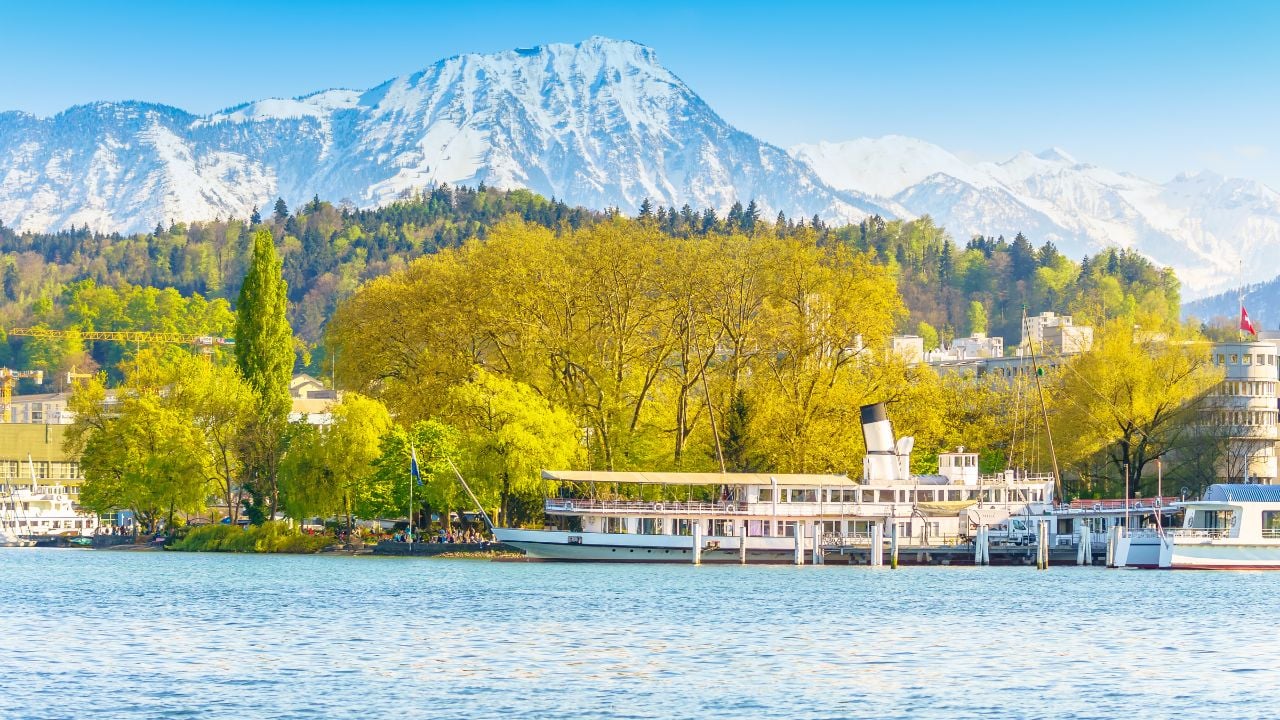 Lucerne, Switzerland - April 29, 2017: Beautiful lake Lucerne with the boat in bright day and beautiful mountain in a background.