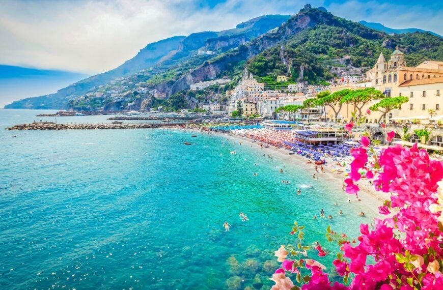 Amalfi town and summer beach with clean blue water and flowers , Italy