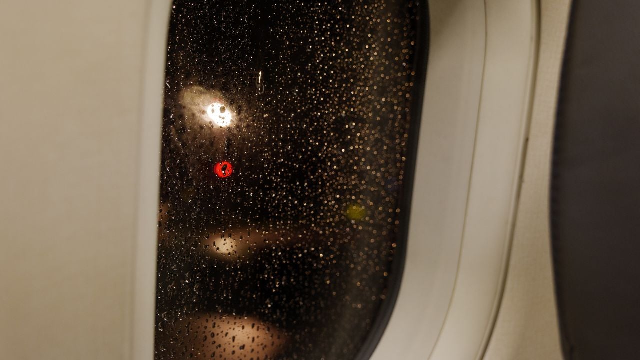Moisture on an airplane window at night.