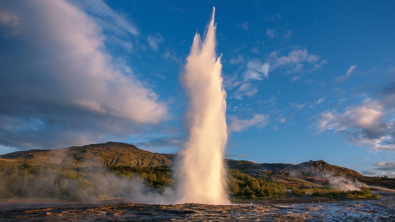 Impressive Eruption of Strokkur Geysir in Iceland during sunset. Strokkur Geyser Popular touristic location and travel destination of Iceland. Wonderful nature landscape.