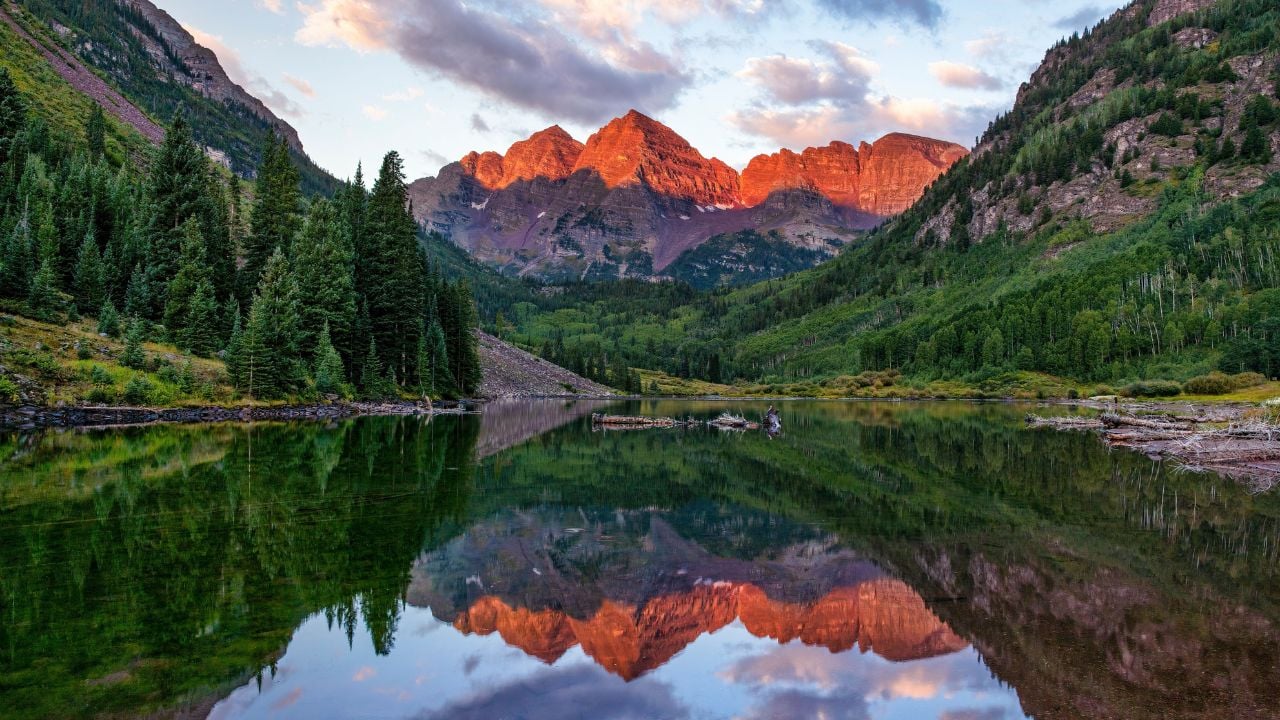 A beautiful landscape of the reflection of Maroon Bells mountain peak on a mirror lake in Colorado