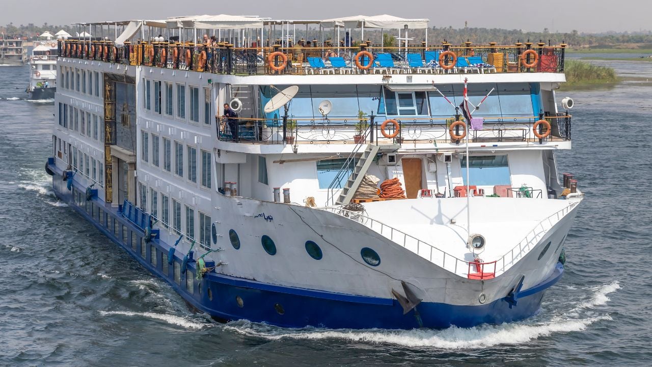 Aswan, Egypt - September 13, 2018: Tourist boat motor down the River Nile towards Aswan in central Egypt. The tourist boats cruise between Luxor and Aswan in Upper Egypt