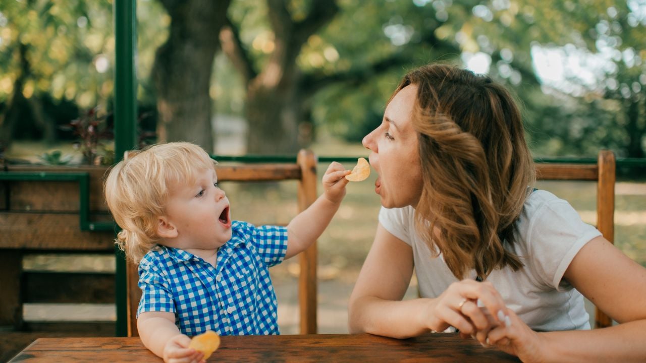 Parent spending time with a young child outdoors.