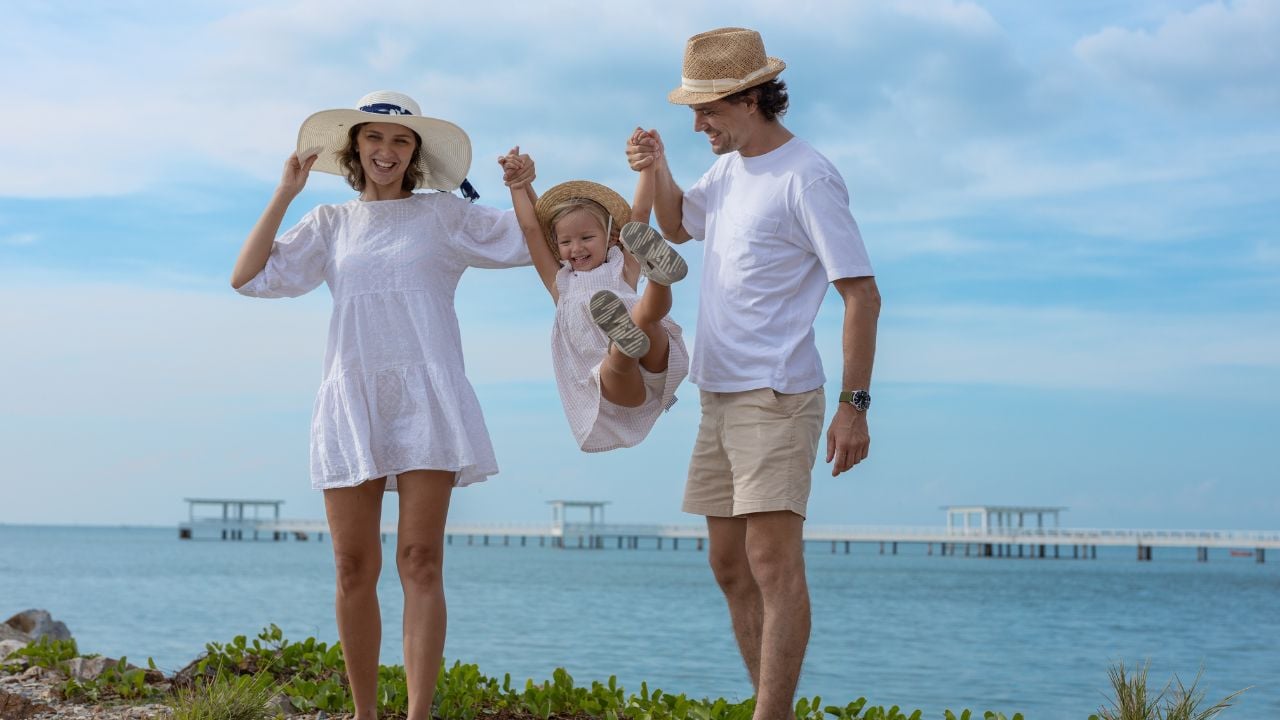 Family relaxing on a beach during vacation.