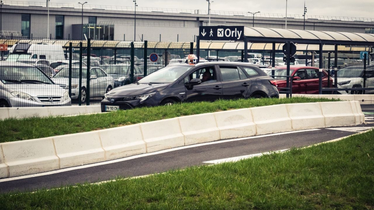 Traditional Paris taxi heading toward Orly Airport.