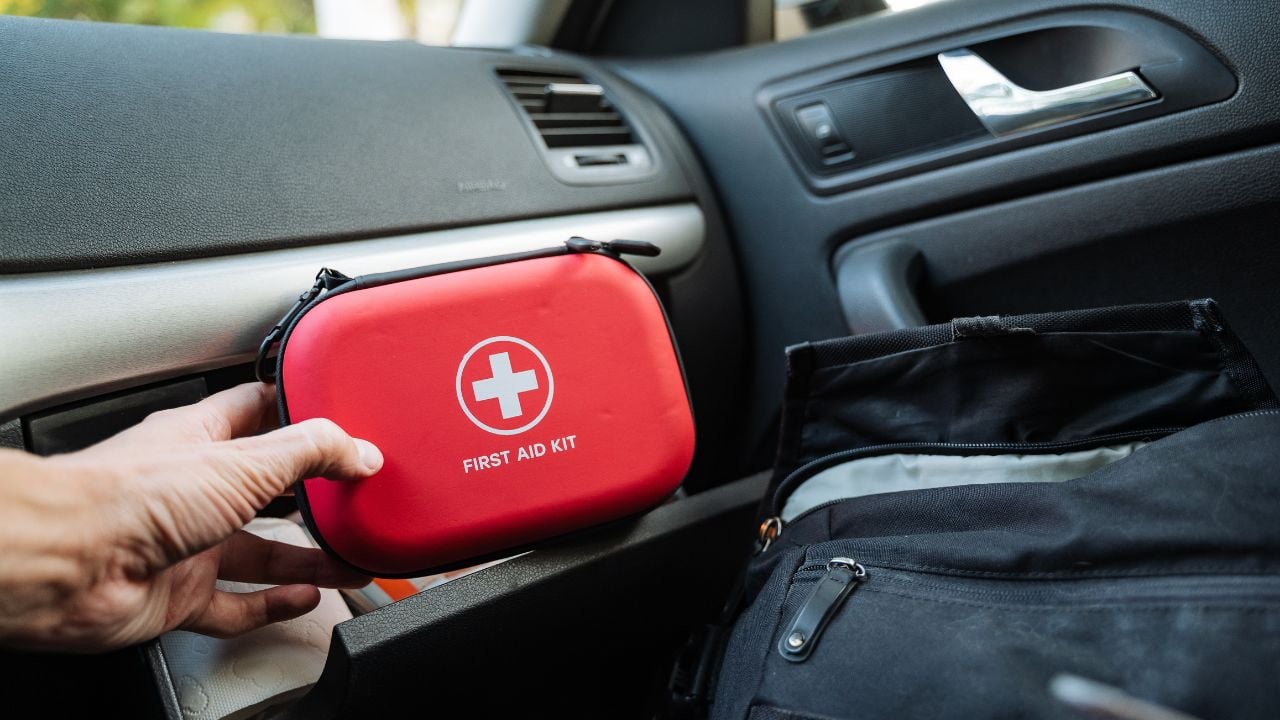Organizing a first aid kit in a car glove compartment.