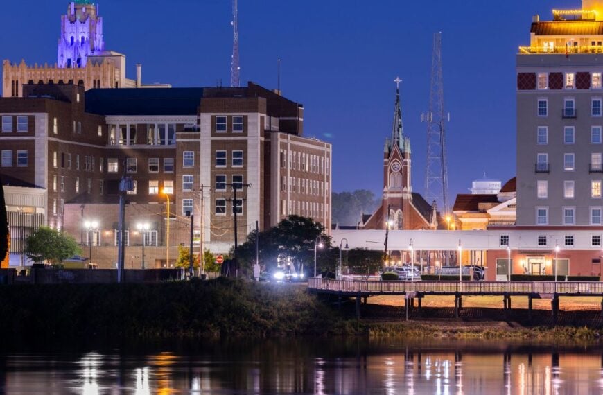 Monroe, Louisiana, USA - April 4, 2024: Evening lights shine on the historic buildings, skyline and river of downtown Monroe.