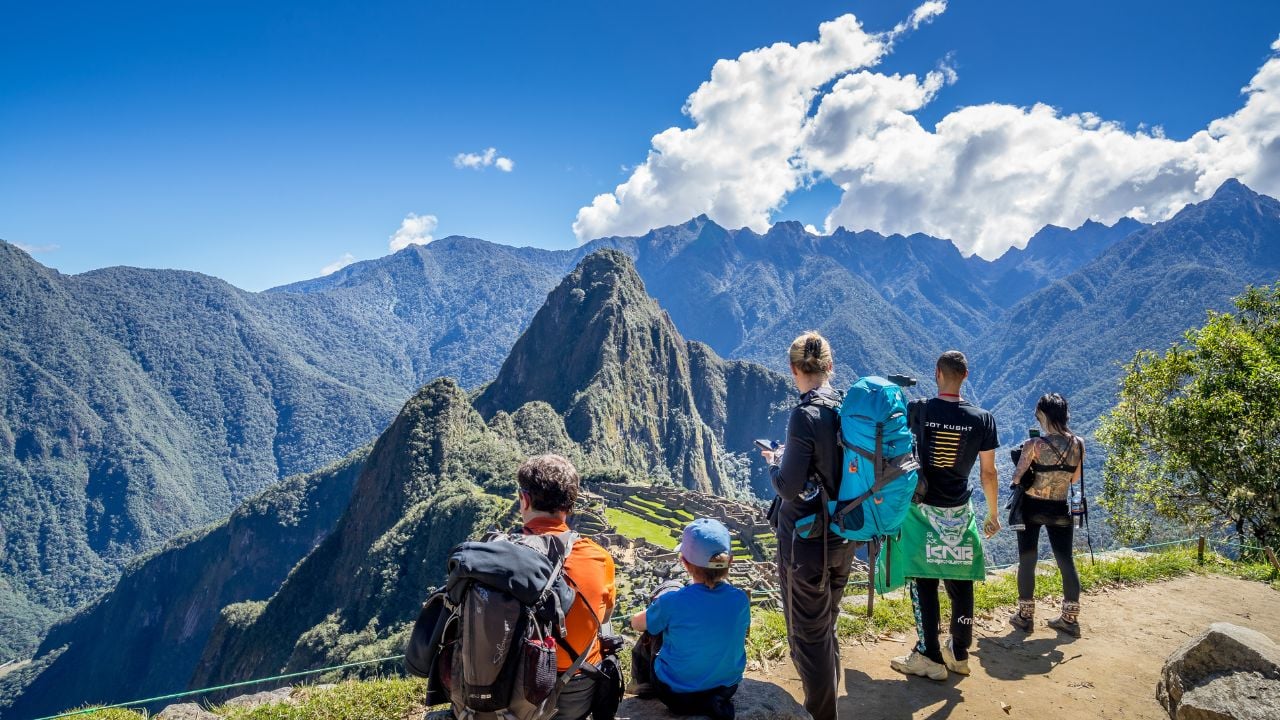 Machu Picchu, Peru - May 2, 2019: Travelers looking at the Inca ruins of Machu Picchu, a UNESCO World Heritage Site in the Cusco Region