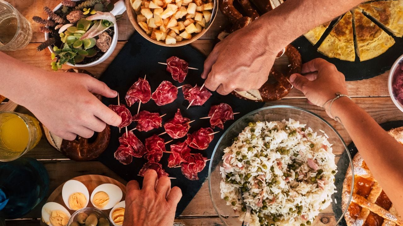 People sharing food from a wooden table