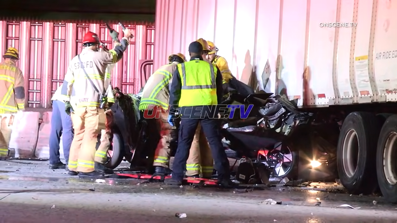 suv crashes under semi