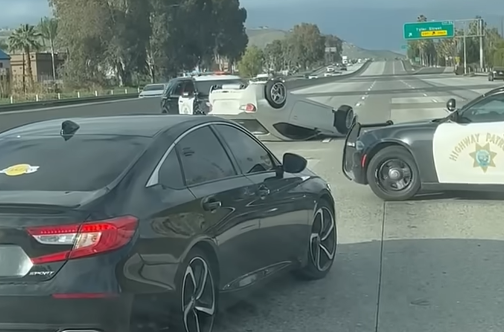 police car moves vehicle across highway
