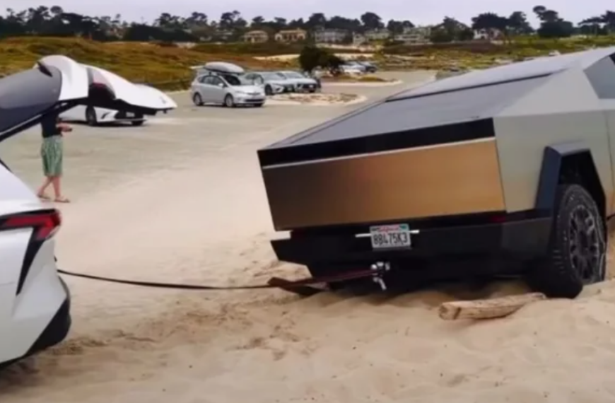 cybertruck getting pulled out of the sand